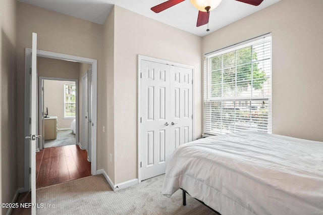7990 Baymeadows Rd Unit 1003, Jacksonville, FL 32256 - carpeted bedroom featuring multiple windows, a closet, and a ceiling fan
