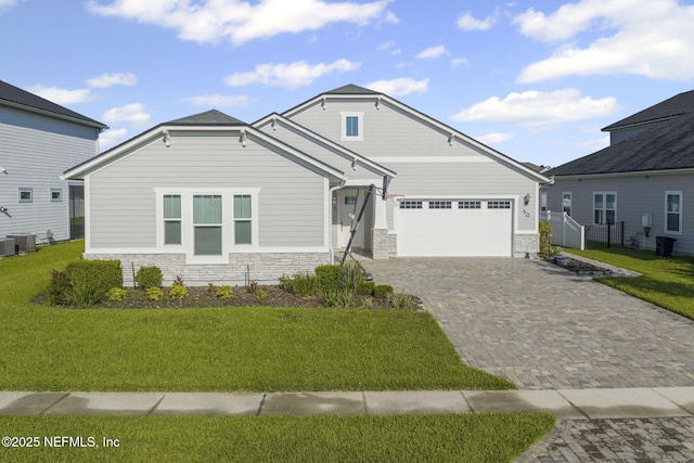 50 Tartan Ct, Saint Augustine, FL 32092 - craftsman-style house with stone siding, decorative driveway, a garage, and a front yard