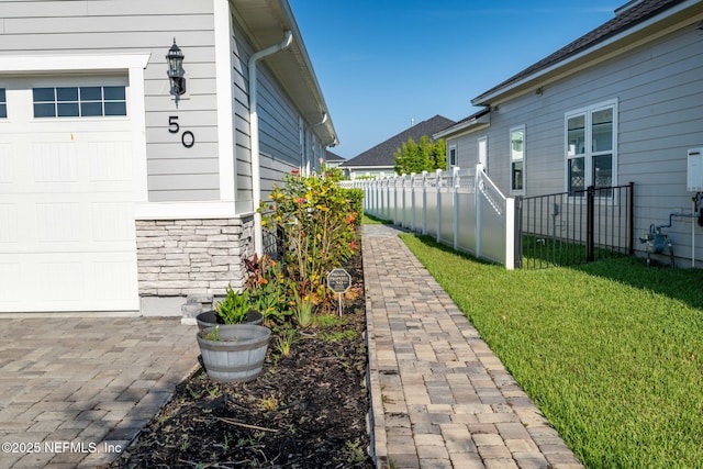 50 Tartan Ct, Saint Augustine, FL 32092 - view of property exterior with stone siding and a garage