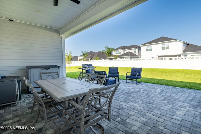 50 Tartan Ct, Saint Augustine, FL 32092 - fenced backyard with outdoor dining area, a patio area, a ceiling fan, a residential view, and area for grilling