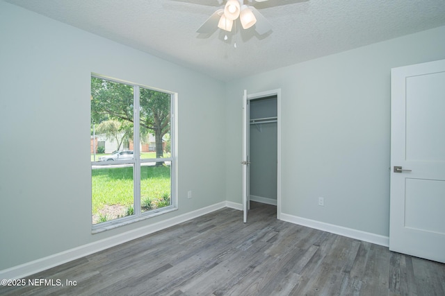 7038 Holiday Hill Ct, Jacksonville, FL 32216 - unfurnished bedroom with wood finished floors, a closet, ceiling fan, and a textured ceiling