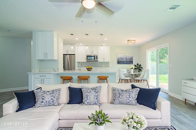 7038 Holiday Hill Ct, Jacksonville, FL 32216 - living area featuring light wood-style flooring and ceiling fan