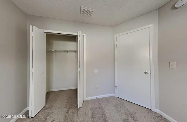 71 Naugatuck Dr, Jacksonville, FL 32225 - unfurnished bedroom featuring carpet, a textured ceiling, and a closet