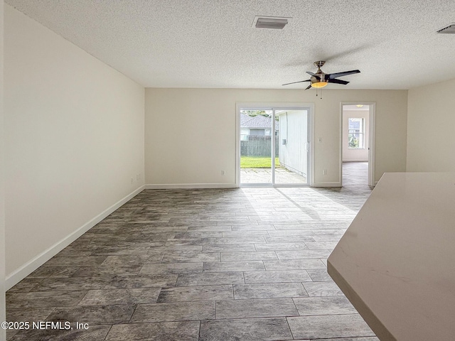 1736 Ashwood Cir, Middleburg, FL 32068 - unfurnished living room featuring a ceiling fan, a textured ceiling, and wood finished floors