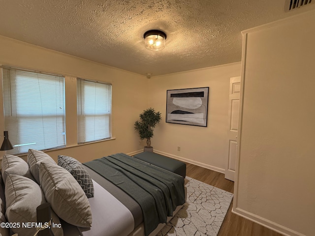 7536 Wakefield Ave, Jacksonville, FL 32208 - bedroom with a textured ceiling and dark wood-style flooring