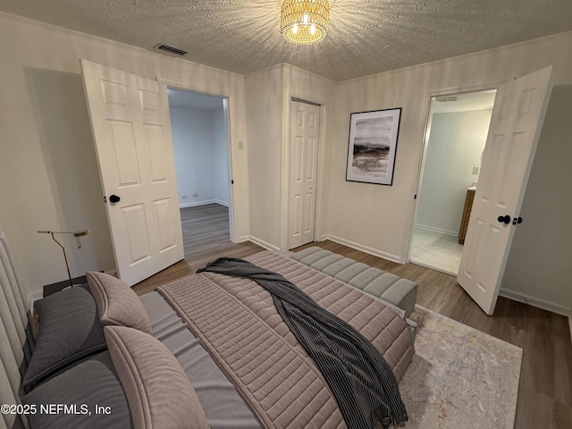 7536 Wakefield Ave, Jacksonville, FL 32208 - bedroom featuring a textured ceiling, wood finished floors, and a closet
