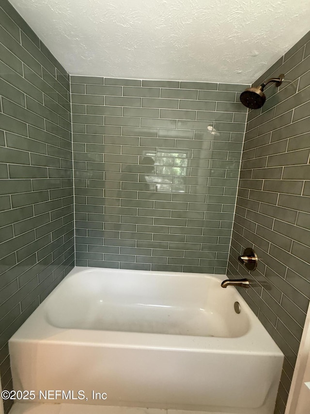 7536 Wakefield Ave, Jacksonville, FL 32208 - full bathroom featuring a textured ceiling and shower / bath combination