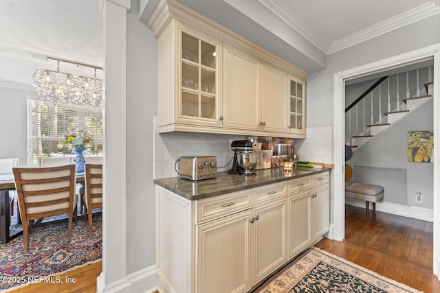 1221 Oriental Gardens Rd, Jacksonville, FL 32207 - bar with wood finished floors, ornamental molding, tasteful backsplash, a chandelier, and stairs