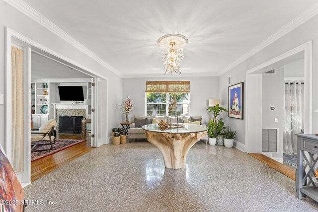 1221 Oriental Gardens Rd, Jacksonville, FL 32207 - foyer featuring ornamental molding, a fireplace, and a chandelier