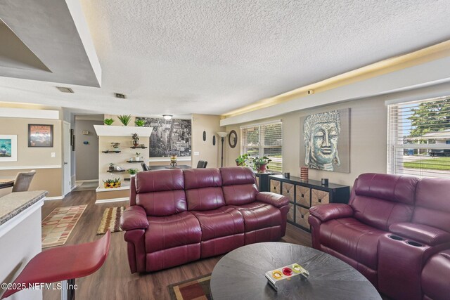 6405 Simca Dr, Jacksonville, FL 32277 - living area featuring a textured ceiling, wood finished floors, and plenty of natural light