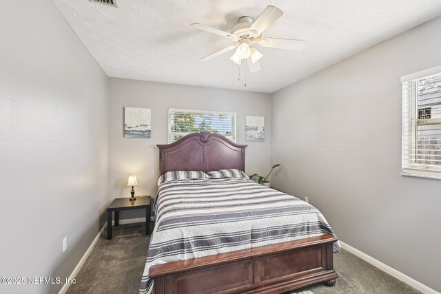 6405 Simca Dr, Jacksonville, FL 32277 - carpeted bedroom with multiple windows, ceiling fan, and a textured ceiling