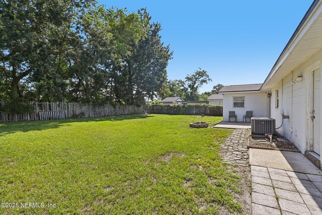 6405 Simca Dr, Jacksonville, FL 32277 - fenced backyard with an outdoor fire pit and a patio area