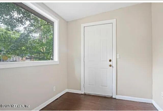8764 3rd Ave, Jacksonville, FL 32208 - entrance foyer with healthy amount of natural light and dark wood-style floors