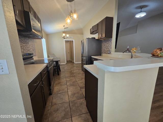 3472 Steelgate Ct, Middleburg, FL 32068 - kitchen featuring appliances with stainless steel finishes, light countertops, tasteful backsplash, vaulted ceiling, and a peninsula