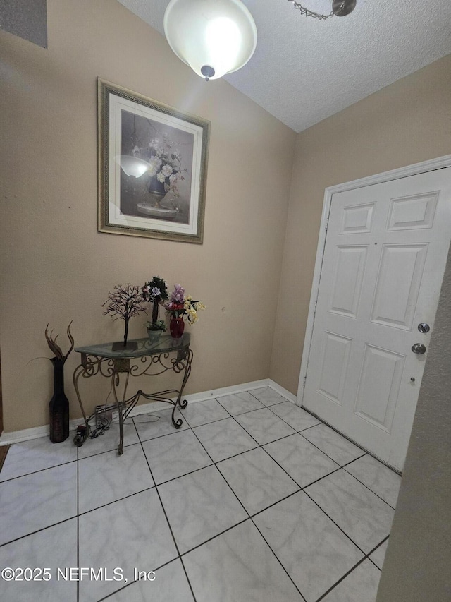 3472 Steelgate Ct, Middleburg, FL 32068 - entryway featuring light tile patterned flooring and a textured ceiling