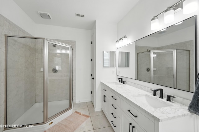 12191 Wynnfield Lakes Cir, Jacksonville, FL 32246 - bathroom with double vanity, a shower stall, and tile patterned floors