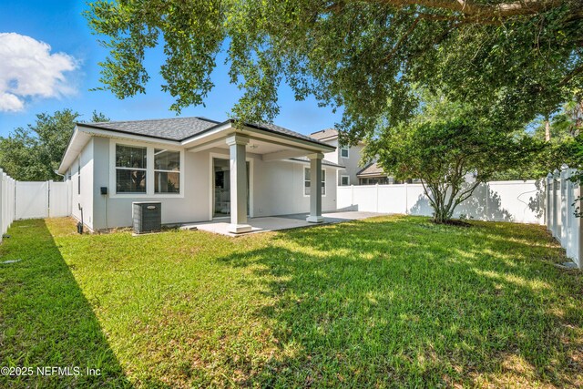 12191 Wynnfield Lakes Cir, Jacksonville, FL 32246 - rear view of property featuring a patio, stucco siding, a fenced backyard, and a shingled roof