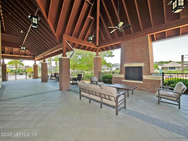 12191 Wynnfield Lakes Cir, Jacksonville, FL 32246 - view of patio featuring an outdoor brick fireplace, a ceiling fan, a gazebo, and outdoor dining area