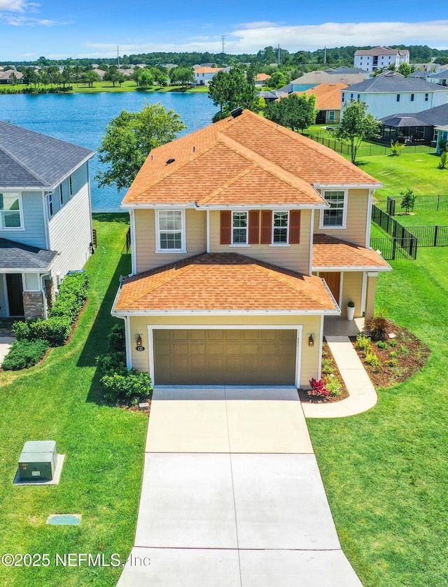 132 Yellowfin Dr, Saint Augustine, FL 32095 - traditional-style house featuring driveway, a garage, a water view, and a shingled roof