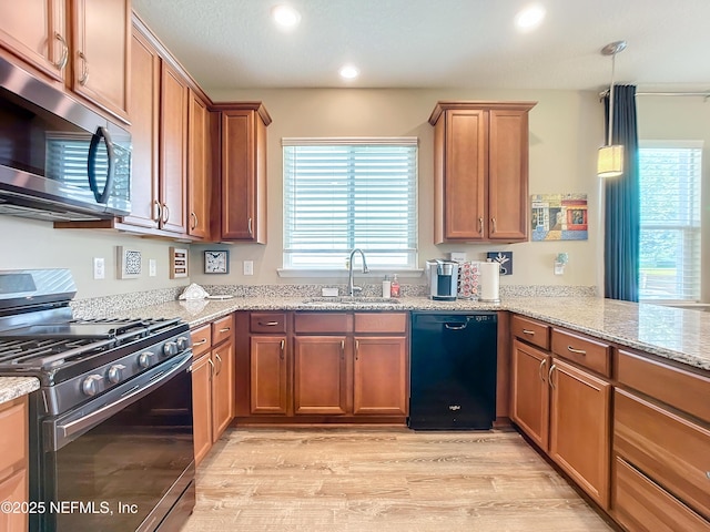 132 Yellowfin Dr, Saint Augustine, FL 32095 - kitchen with appliances with stainless steel finishes, recessed lighting, light wood-type flooring, light stone counters, and brown cabinetry