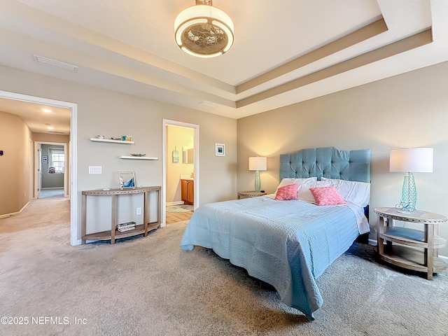 132 Yellowfin Dr, Saint Augustine, FL 32095 - carpeted bedroom with a tray ceiling and connected bathroom