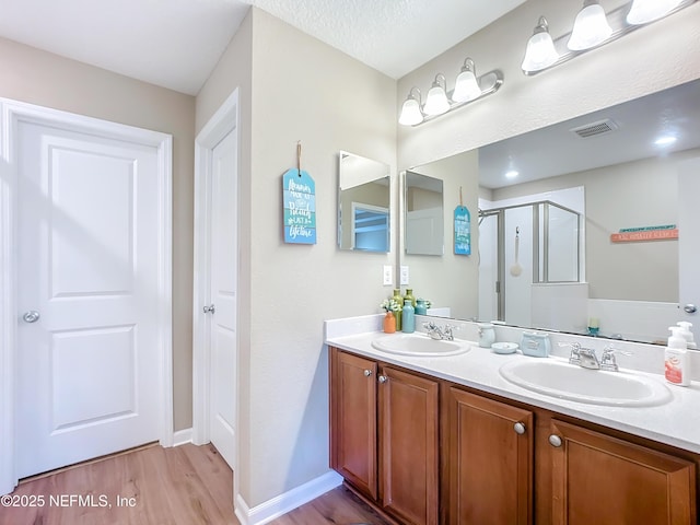 132 Yellowfin Dr, Saint Augustine, FL 32095 - full bathroom featuring a shower stall, wood finished floors, and double vanity