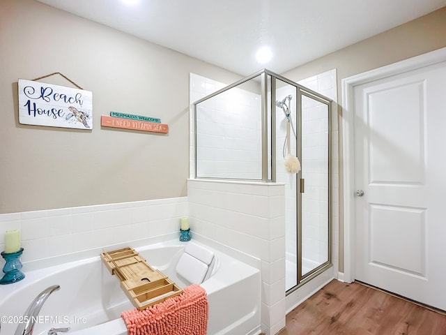 132 Yellowfin Dr, Saint Augustine, FL 32095 - full bathroom featuring a bath, a stall shower, and wood finished floors