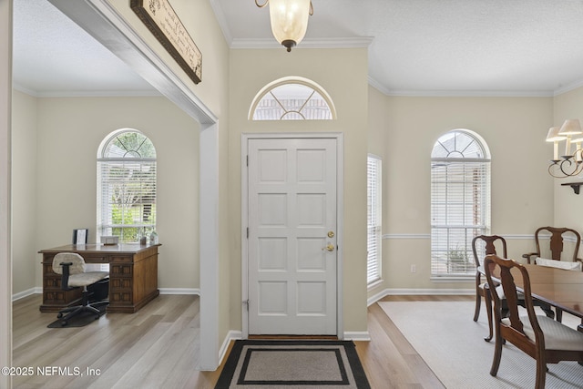 6992 Tonga Dr, Jacksonville, FL 32216 - entrance foyer with wood finished floors, crown molding, and a chandelier