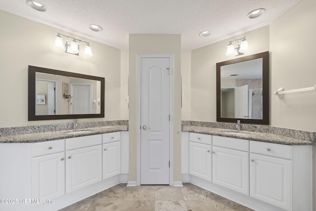 6992 Tonga Dr, Jacksonville, FL 32216 - bathroom with two vanities and a textured ceiling