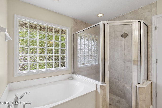 6992 Tonga Dr, Jacksonville, FL 32216 - bathroom featuring a bath, a shower stall, and recessed lighting