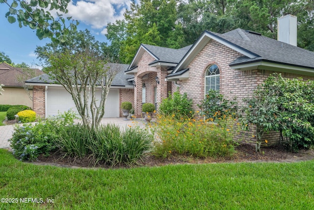 6992 Tonga Dr, Jacksonville, FL 32216 - view of front of home featuring brick siding, roof with shingles, an attached garage, concrete driveway, and a chimney