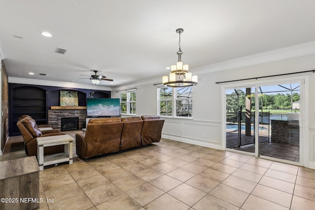 738 W Kings College Dr, Fruit Cove, FL 32259 - living area with a ceiling fan, ornamental molding, a fireplace, plenty of natural light, and a chandelier