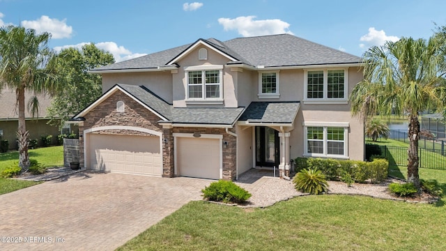 738 W Kings College Dr, Fruit Cove, FL 32259 - traditional-style home with stucco siding, decorative driveway, stone siding, an attached garage, and a shingled roof