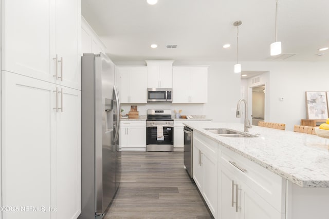 380 Jefferson Rd, Jacksonville, FL 32225 - kitchen featuring stainless steel appliances, white cabinetry, dark wood-style flooring, a center island with sink, and recessed lighting