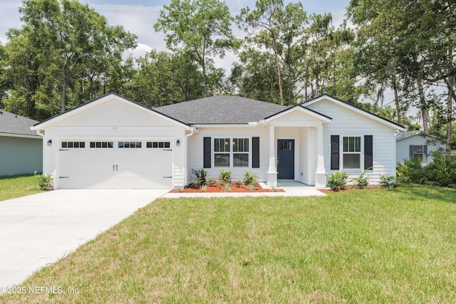 380 Jefferson Rd, Jacksonville, FL 32225 - view of front of house with an attached garage, concrete driveway, a front yard, and a shingled roof