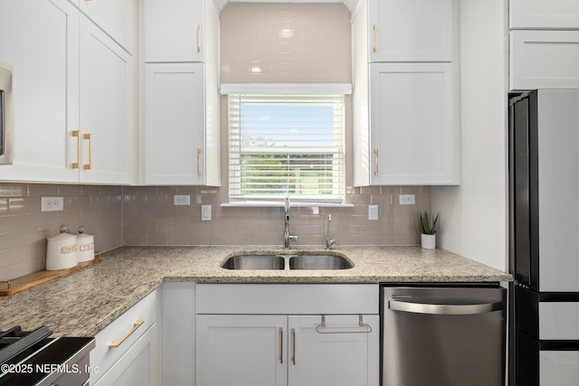 111 Beam Ln, Saint Augustine, FL 32095 - kitchen with dishwasher, freestanding refrigerator, white cabinets, and decorative backsplash