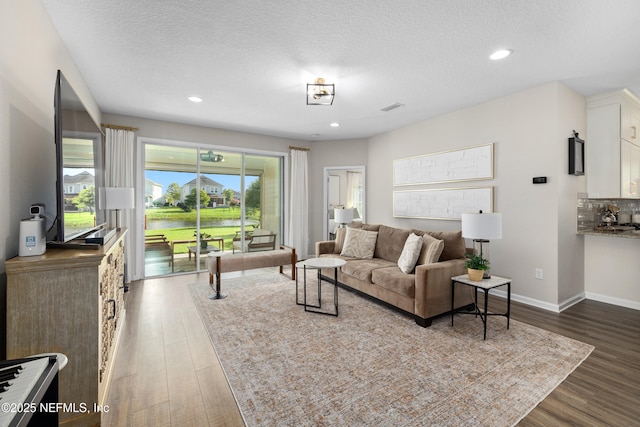 111 Beam Ln, Saint Augustine, FL 32095 - living room with wood finished floors, a textured ceiling, and recessed lighting