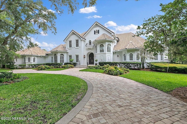 24736 Harbour View Dr, Ponte Vedra Beach, FL 32082 - mediterranean / spanish home featuring curved driveway, a front lawn, and stucco siding