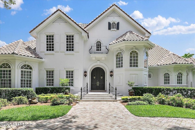 24736 Harbour View Dr, Ponte Vedra Beach, FL 32082 - mediterranean / spanish-style house with a tiled roof, stucco siding, and a balcony
