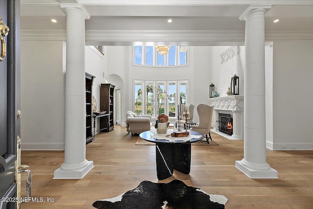 24736 Harbour View Dr, Ponte Vedra Beach, FL 32082 - living room featuring ornate columns, light wood-style flooring, a high end fireplace, recessed lighting, and crown molding