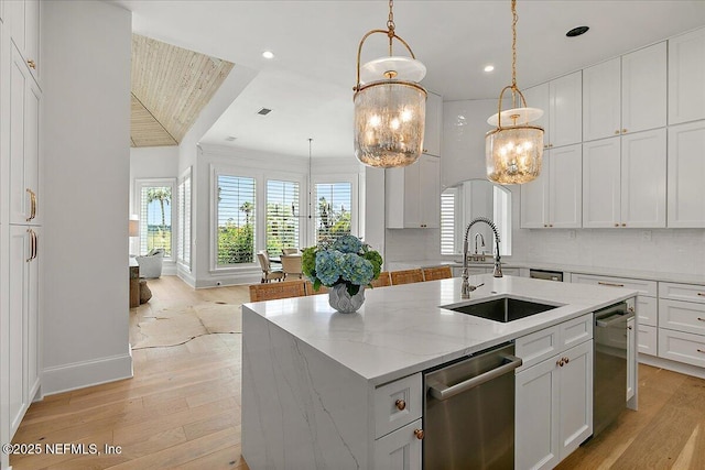 24736 Harbour View Dr, Ponte Vedra Beach, FL 32082 - kitchen with dishwasher, a chandelier, a kitchen island with sink, light wood finished floors, and white cabinetry
