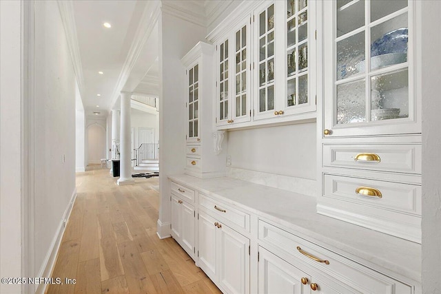24736 Harbour View Dr, Ponte Vedra Beach, FL 32082 - bar area featuring ornamental molding, light wood-style flooring, ornate columns, and recessed lighting