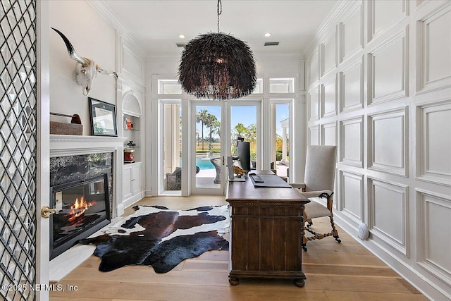 24736 Harbour View Dr, Ponte Vedra Beach, FL 32082 - office area with a high end fireplace, built in features, crown molding, light wood-style floors, and french doors