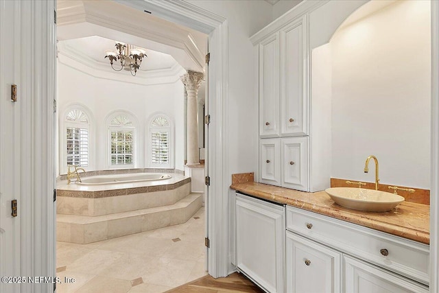 24736 Harbour View Dr, Ponte Vedra Beach, FL 32082 - bathroom featuring a garden tub, vanity, tile patterned flooring, a chandelier, and ornate columns