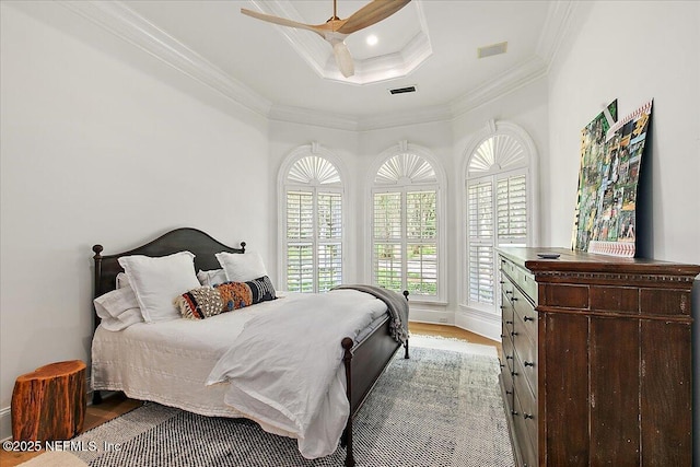24736 Harbour View Dr, Ponte Vedra Beach, FL 32082 - bedroom with crown molding, wood finished floors, a raised ceiling, and a ceiling fan