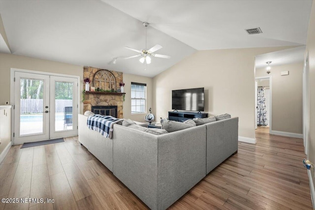 2168 Minorcan St, Middleburg, FL 32068 - living room with wood finished floors, a ceiling fan, french doors, lofted ceiling, and a stone fireplace