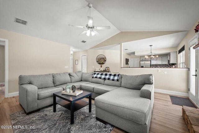 2168 Minorcan St, Middleburg, FL 32068 - living area with vaulted ceiling, light wood finished floors, a chandelier, and ceiling fan