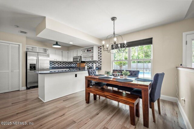 2168 Minorcan St, Middleburg, FL 32068 - dining room featuring a chandelier and light wood-type flooring