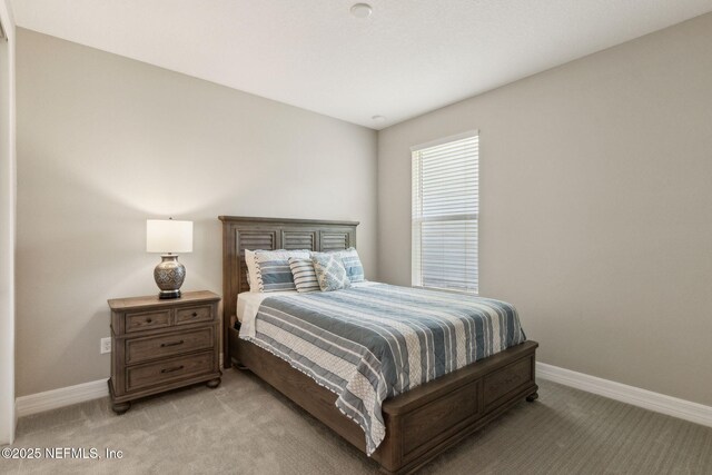 613 Witty Banter Ct, Yulee, FL 32097 - bedroom with light carpet and baseboards