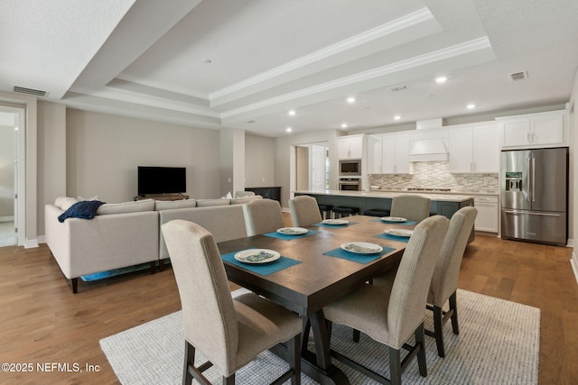 613 Witty Banter Ct, Yulee, FL 32097 - dining area featuring a tray ceiling, crown molding, dark wood finished floors, and recessed lighting